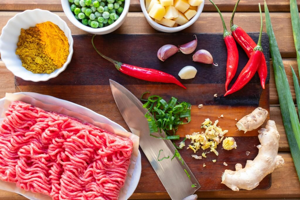 Fresh ingredients displayed on a cutting board, perfect for preparing a spicy beef stir fry.